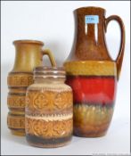A set of three 1970's retro West German fat lava decorative ceramic pots / vases of varying form.