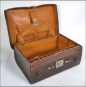 A good quality leather cased gentlemans vanity suitcase with central monogram.