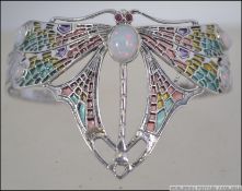 A silver plique a jour ladies Art Nouveau bangle in the form of a dragonfly.