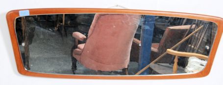 A large long retro 1970's atomic shaped teak wood frameless wall mirror.