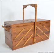 A retro 1950's metamorphic sewing box with carry handle being of unusual form.