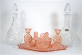A 1930's Art Deco peach glass dressing table set complete with the tray together with a pair of cut