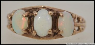 A 10ct gold and opal ring, the 3 cabochon opals being claw mounted.