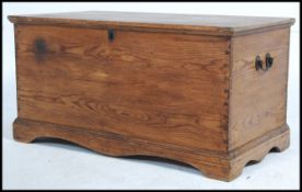 A large 19th century French pine blanket box chest having hinged top over panel sides with handles.
