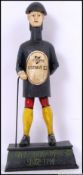 A cast iron Guinness figure of a gentleman wearing a Guiness top with a walking cane. 35cm long.
