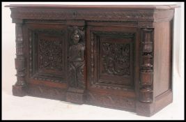 An 18th / 19th century carved oak small Jacobean sideboard coffer having twin carved fielded