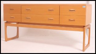 A 1970's retro G-Plan Kelso teak wood double bank chest of drawers with recess handles raised on