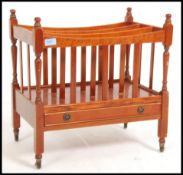 A 20th Century yew wood Canterbury magazine rack with drawer below being raised on turned legs with