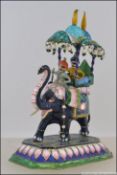 A late 19th / early 20th century silver and enamel model of an elephant with a howdah atop.