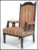 A late Victorian aesthetic movement oak armchair ebonised frame and a contempory stripped