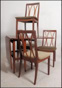 A set of four 1970's G-Plan teak lattice back retro dining chairs raised on tapered legs with