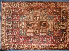 A large Persian handwoven rug of square medallion form having birds, tree of life,