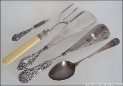A collection of silver items to include rococo silver handled shoe horns, toasting fork,