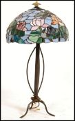 A 20th century Tiffany style multicoloured glass shaded lamp, on a metal base.