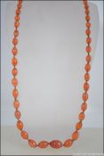 A 9ct gold clasped vintage string knotted believed Carnelian stone ladies bead necklace,
