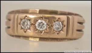 A 9ct gold and diamond 3 stone band ring, The inset diamonds approx 10pnts each. Total weight 6.