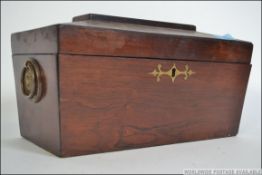 A Georgian rosewood inlaid sarcophagus shaped tea caddy complete with the twin sectional caddy's to