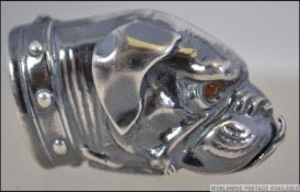A 20th century silver plated vesta case in the form of a boxer dog having inset glass eyes.