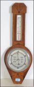 A 1930's Art Deco walnut barometer having silvered dial with thermometer to the neck.