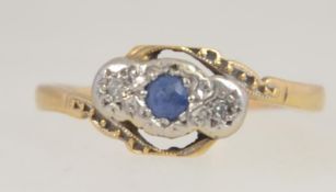 An 18ct gold, sapphire and diamond ring. The central sapphire flanked by diamonds in star settings.
