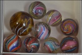 A collection of 9 good early 20th century marbles to include helix twist, spiral etc.