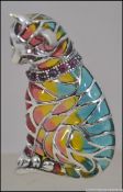 A silver plique a jour cat brooch of decorative form being multicoloured with pin verso.