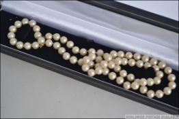 A silver white metal box link necklace measures 16 inches along with a faux pearl necklace a green