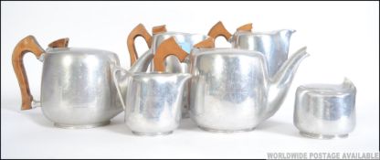 A 1950's 4 piece Piquet Ware stainless polished steel and wooden service together with 2 similar