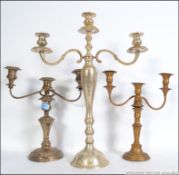 A collection of silver plated candelabra to include a large 3 sconce example measuring 56cms high