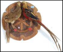 A good male and female pair of taxidermy golden pheasants mounted on a plaque, circa 20th century.