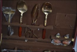 A 20th century cased canteen of cutlery containing a bronze and wooden studded handles,