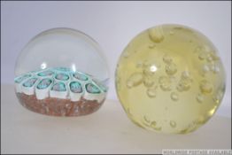 Two glass paperweights to include a millefiori paperweight and a control bubble. Largest 7.
