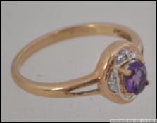A 9ct gold and amethyst diamond ladies ring being marked 375 having diamond chip surrounded