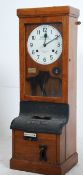 An early 20th century wall mounted mahogany cased National Time Recorder with circular dial set