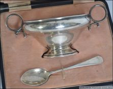 A silver hallmarked twin handled feeding bowl and matching spoon set in it's original leather
