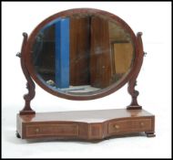 A good Georgian mahogany toilet swing mirror raised over shaped base with oval swing mirror atop.