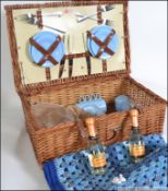 A vintage whicker picnic hamper together with a handmade picnic blanket basket with fitted interior