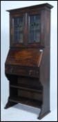 A late 19th / early 20th Century Arts & Crafts oak students bureau bookcase with with two Art