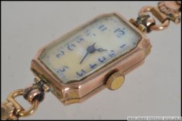 A vintage 9ct gold cocktail watch having a enamel face with a Swiss 10 Jewel movement.