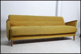 A 1960's original teak Danish influence sofa day bed in the manner of Scandart.