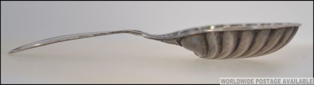 A Victorian silver hallmarked caddy spoon with oyster bowl and short stem handle by Henry Wilkinson