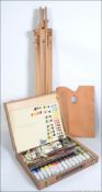 An artists cased oil painting set being complete with oils,