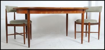 A mid-20th century G-Plan teak D-end pull out extending dining table with a single additional fold