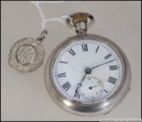 A silver early 20th century crown wind pocket watch with enamel face having faceted hands and