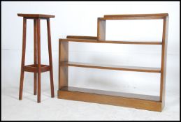 A 1930's oak open window bookcase cabinet with shelves and locker door together with an oak plant