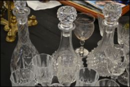 A large collection of cut glass crystal glasses and decanters to include wine glasses, tumblers,
