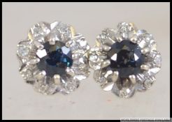 A pair of 9ct white gold and sapphire diamond ear studs earrings complete in the presentation box.