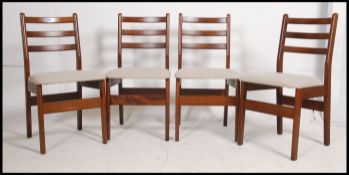 A set of 4 retro 1970's Danish influence teak wood bar back dining chairs raised on shaped legs