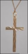A 9ct gold engine turned cross - crucifix necklace pendant complete with chain and clasp ,