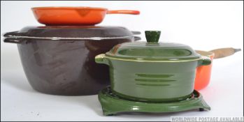 A collection of Le Creuset pans and lids to include a Skillet pan,